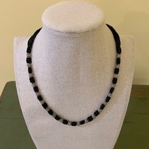 Black beads and silver necklace.